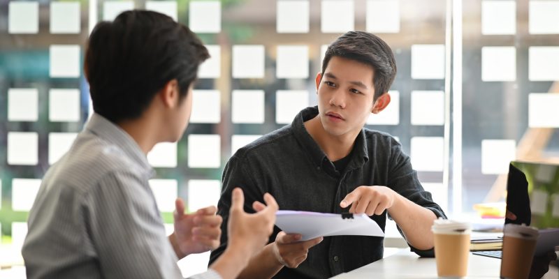 asian-young-man-consulting-with-paper-document-on-modern-office-.jpg